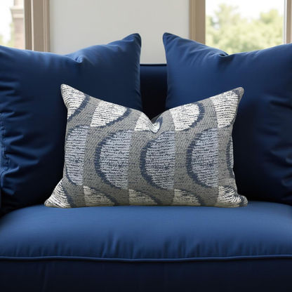 Decorative pillow with a wavy pattern on a blue sofa