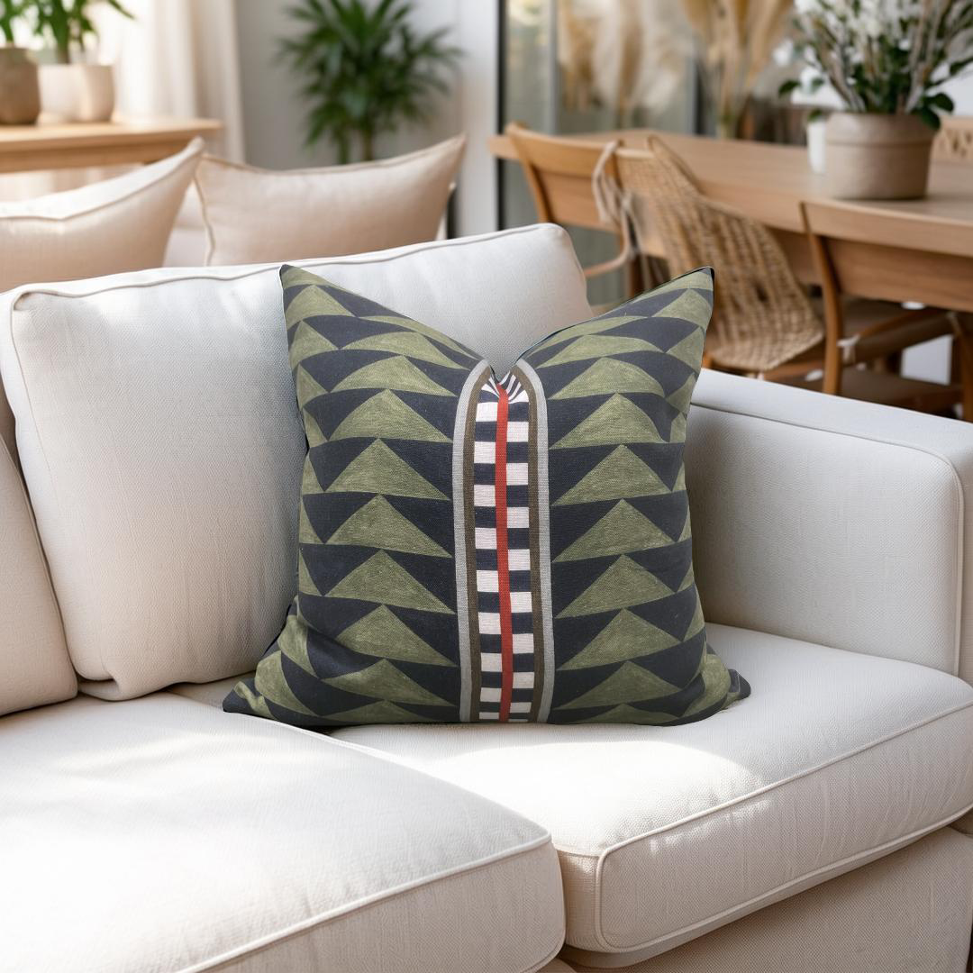 Decorative pillow with geometric pattern on a beige sofa in a home setting