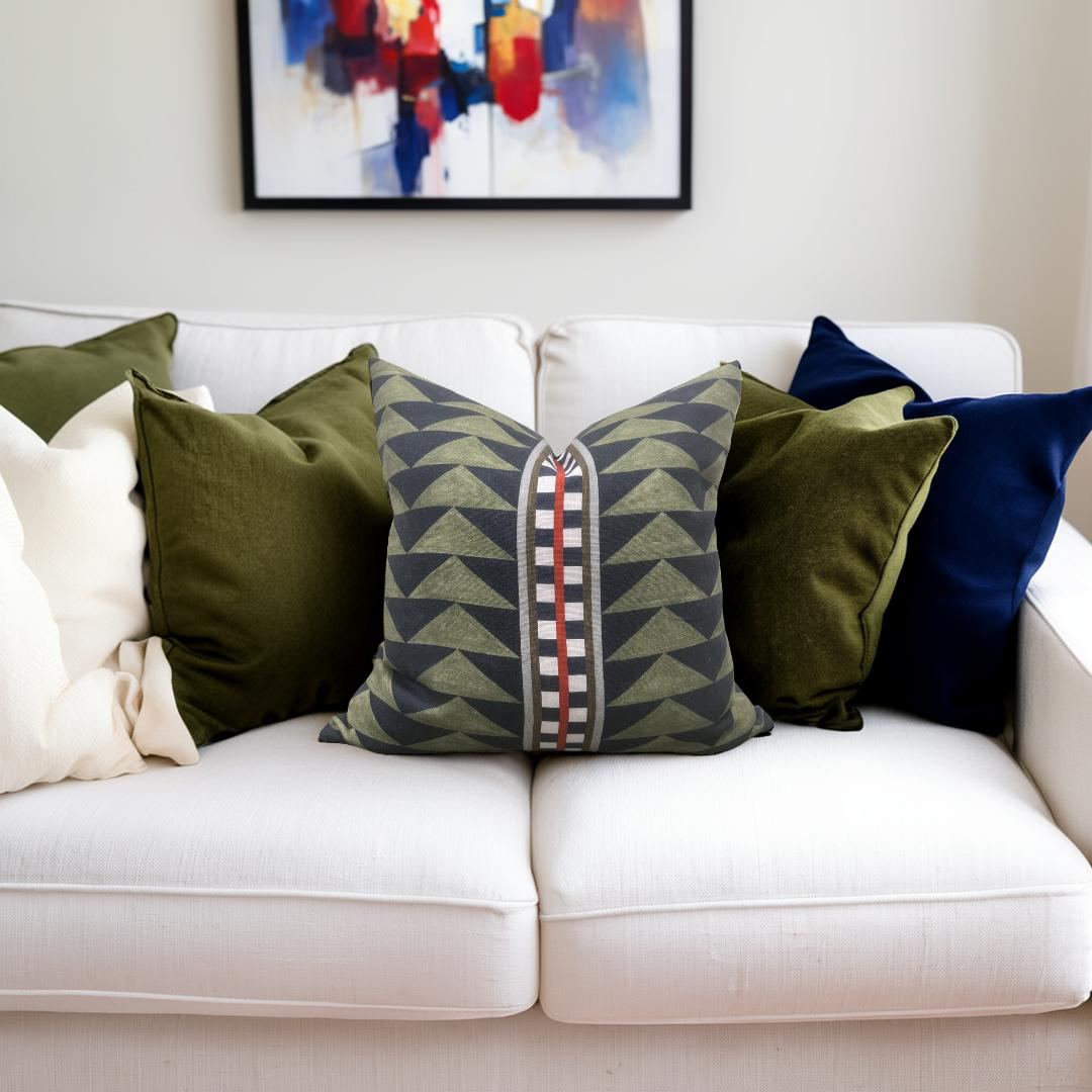White sofa with colorful pillows and a abstract painting in the background