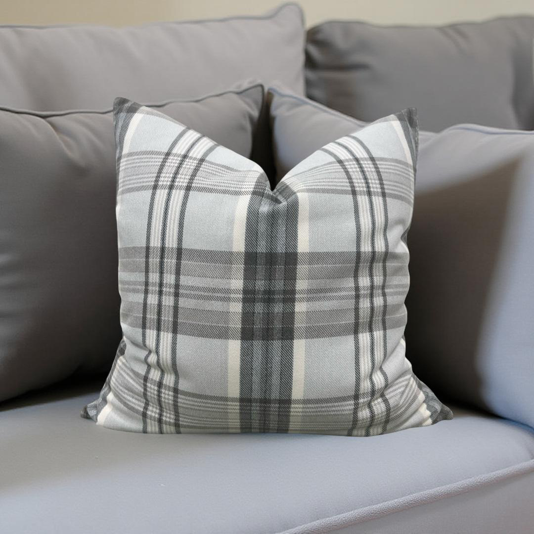 Plaid pillow on a gray sofa