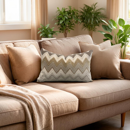 Beige sofa with patterned pillow in a living room setting