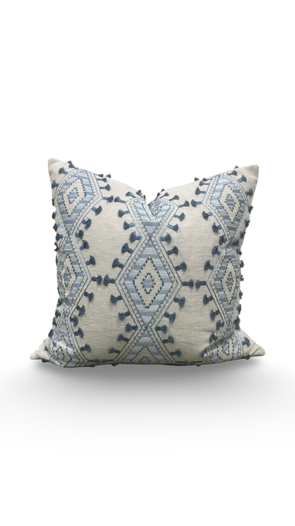 Decorative pillow with blue geometric pattern on a white background