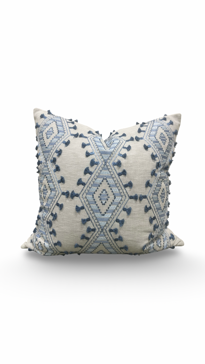 Decorative pillow with blue geometric pattern on a white background