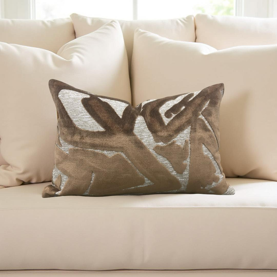 Decorative pillow with leaf pattern on a beige sofa