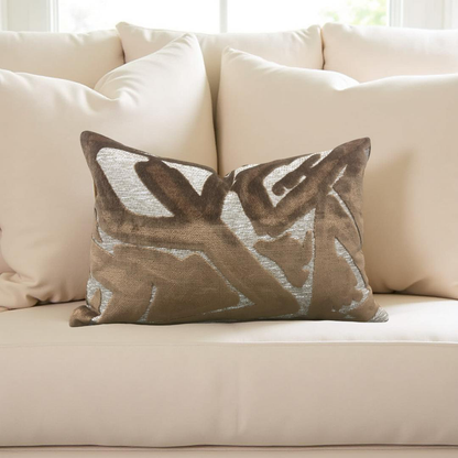 Decorative pillow with leaf pattern on a beige sofa