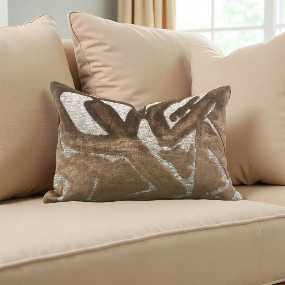 Decorative pillow with leaf pattern on a beige sofa