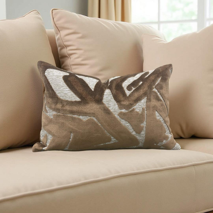 Decorative pillow with leaf pattern on a beige sofa