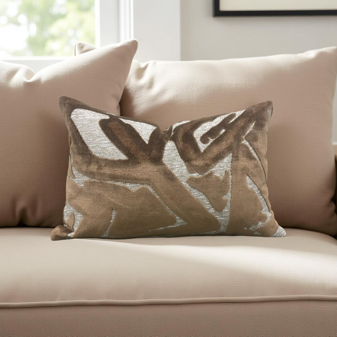 Decorative pillow with leaf pattern on a beige sofa