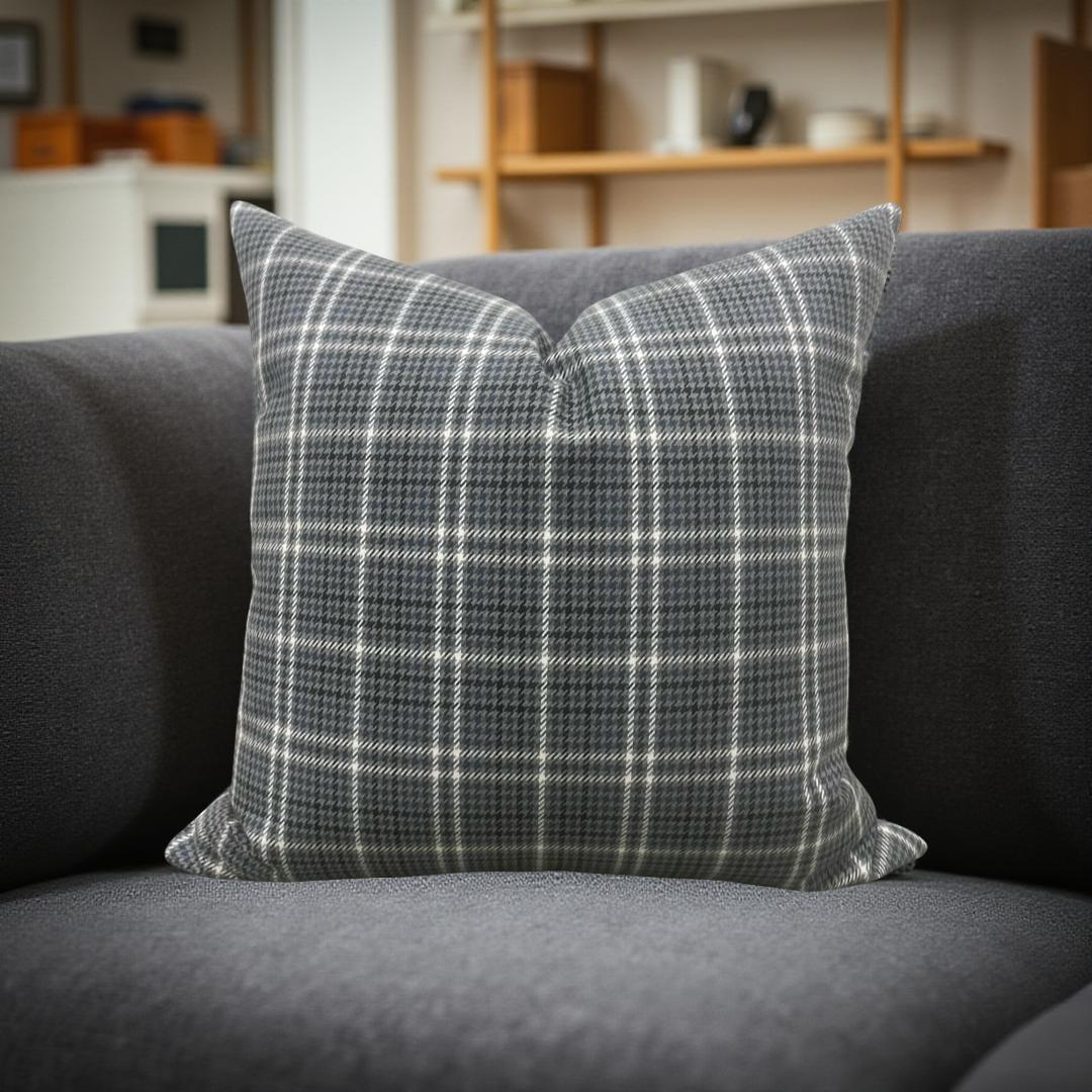 Plaid pillow on a gray sofa with a blurred background
