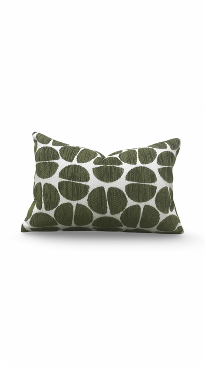 Green patterned pillow on a white background