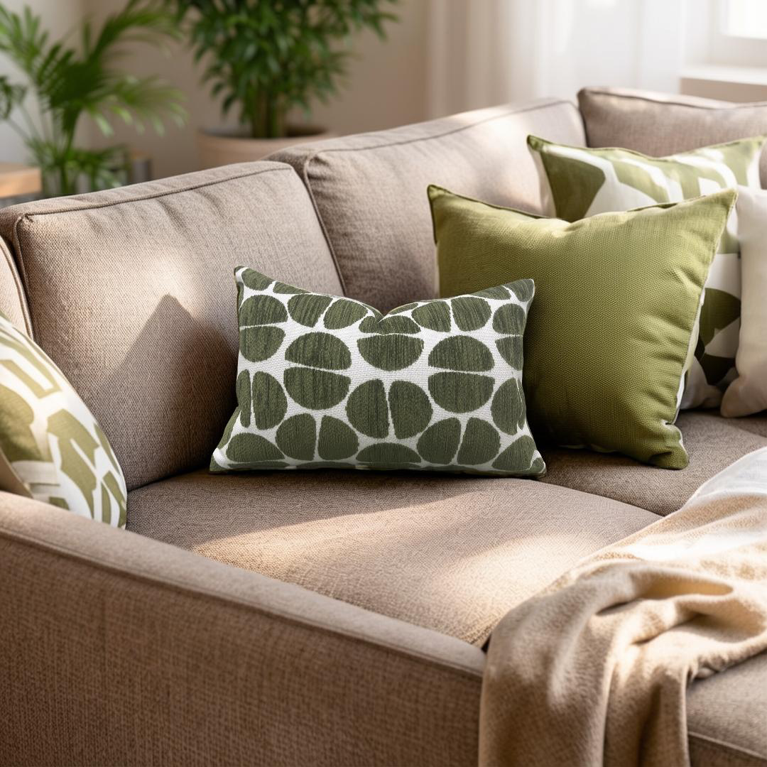 Beige sofa with green patterned pillows in a living room setting