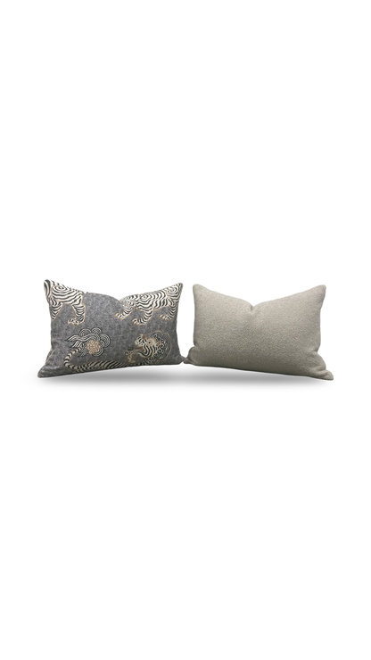Two gray pillows with decorative patterns on a white background