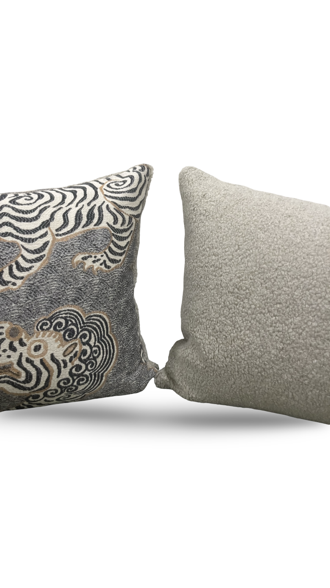 Two decorative pillows, one with a zebra pattern and the other plain gray, on a white background.
