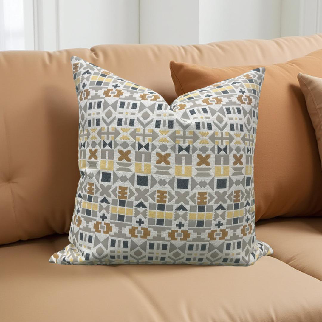 Decorative pillow with geometric pattern on a beige sofa