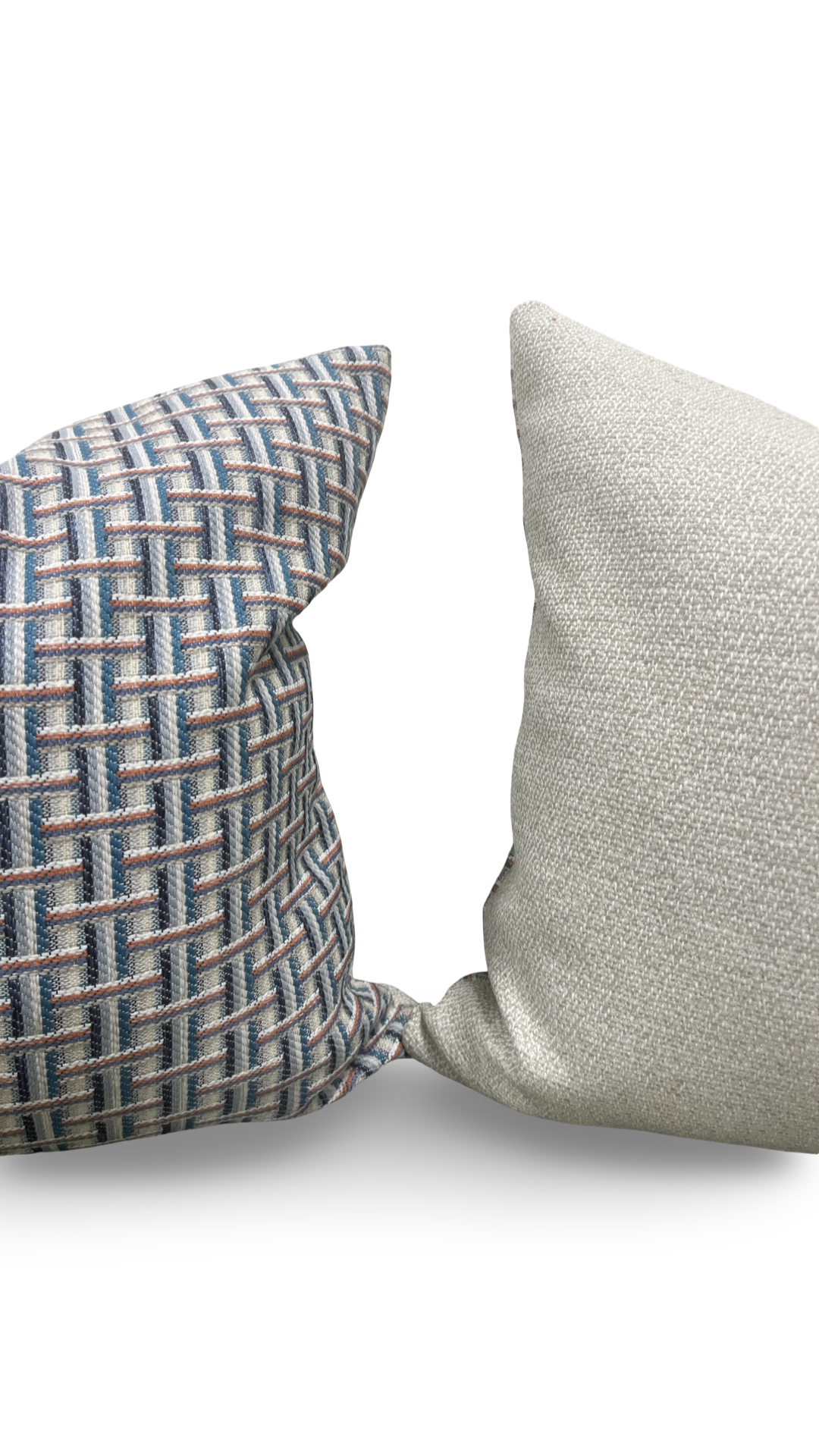 Two textured pillows, one with a geometric pattern and the other plain, on a light background.