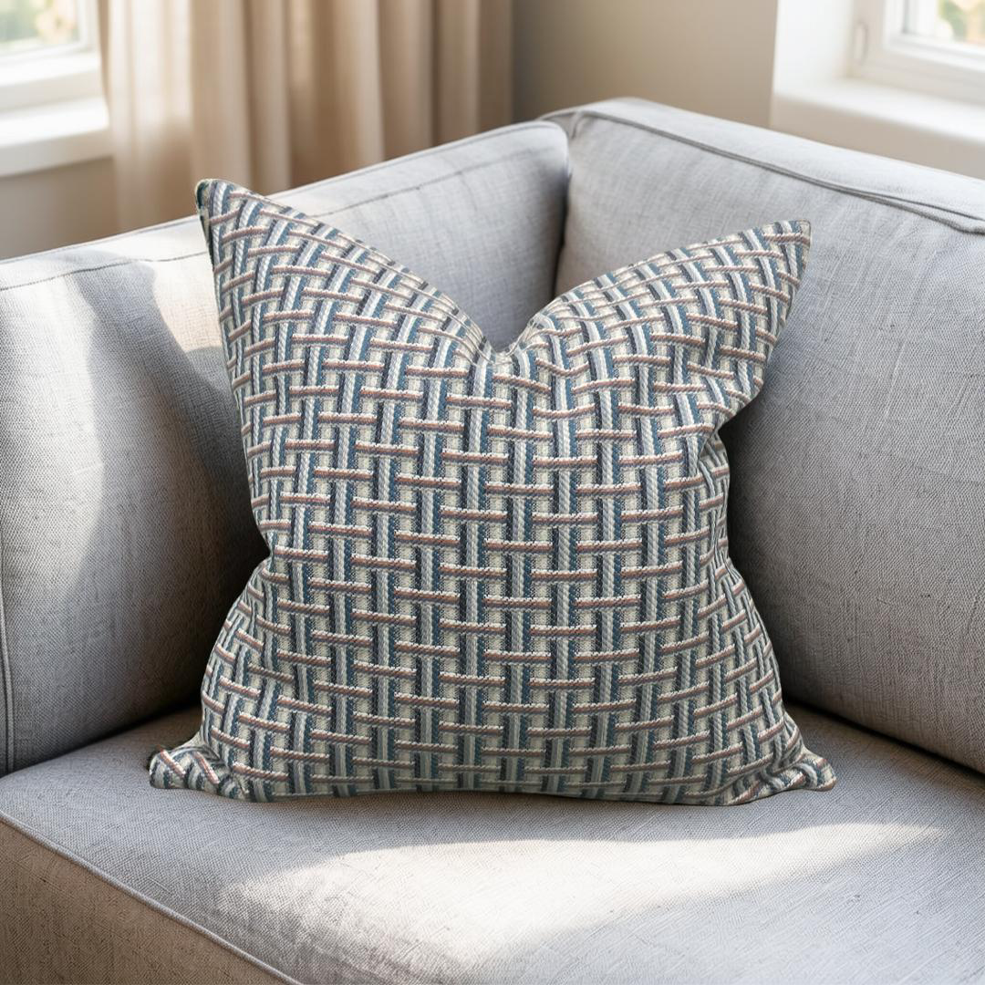 Patterned pillow on a gray sofa with a neutral background