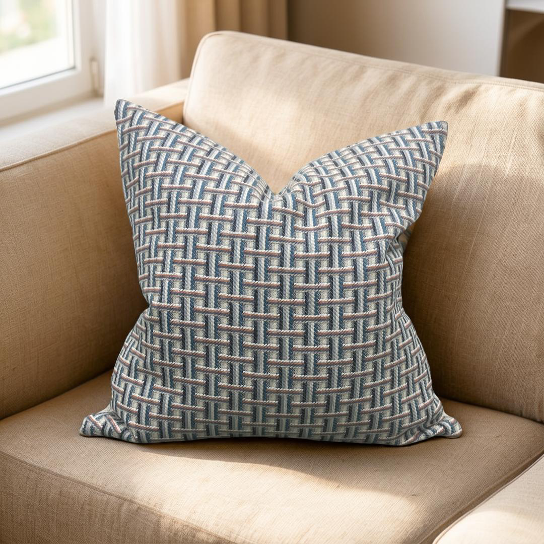 Decorative pillow with a geometric pattern on a beige couch.