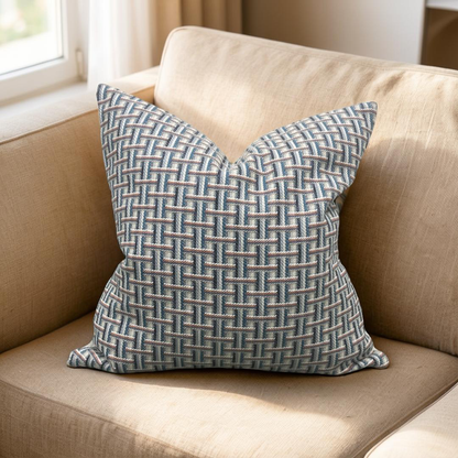 Decorative pillow with a geometric pattern on a beige couch.