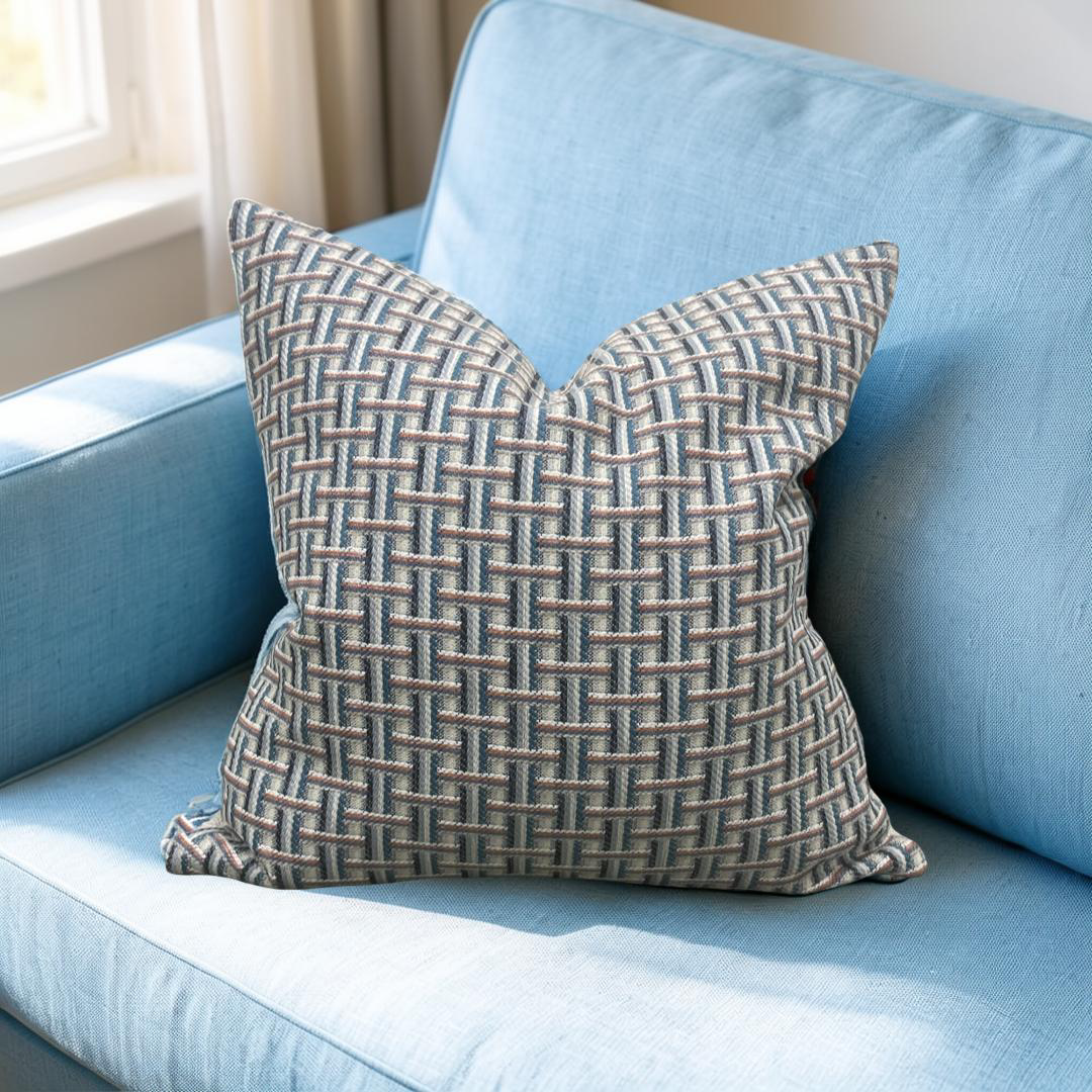 Textured pillow on a light blue sofa with a neutral background