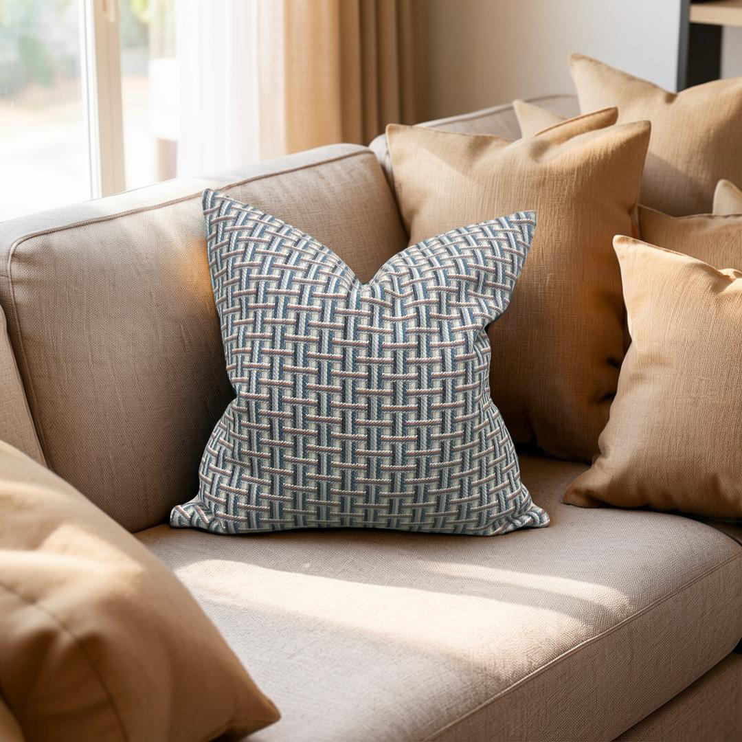 Beige sofa with patterned blue pillow in a bright room