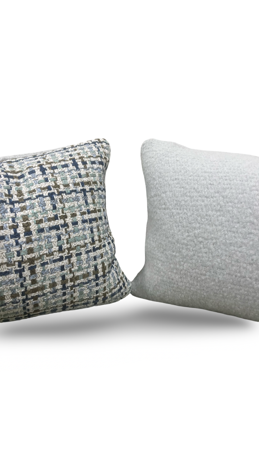 Two pillows, one with a textured pattern and one plain, on a white background