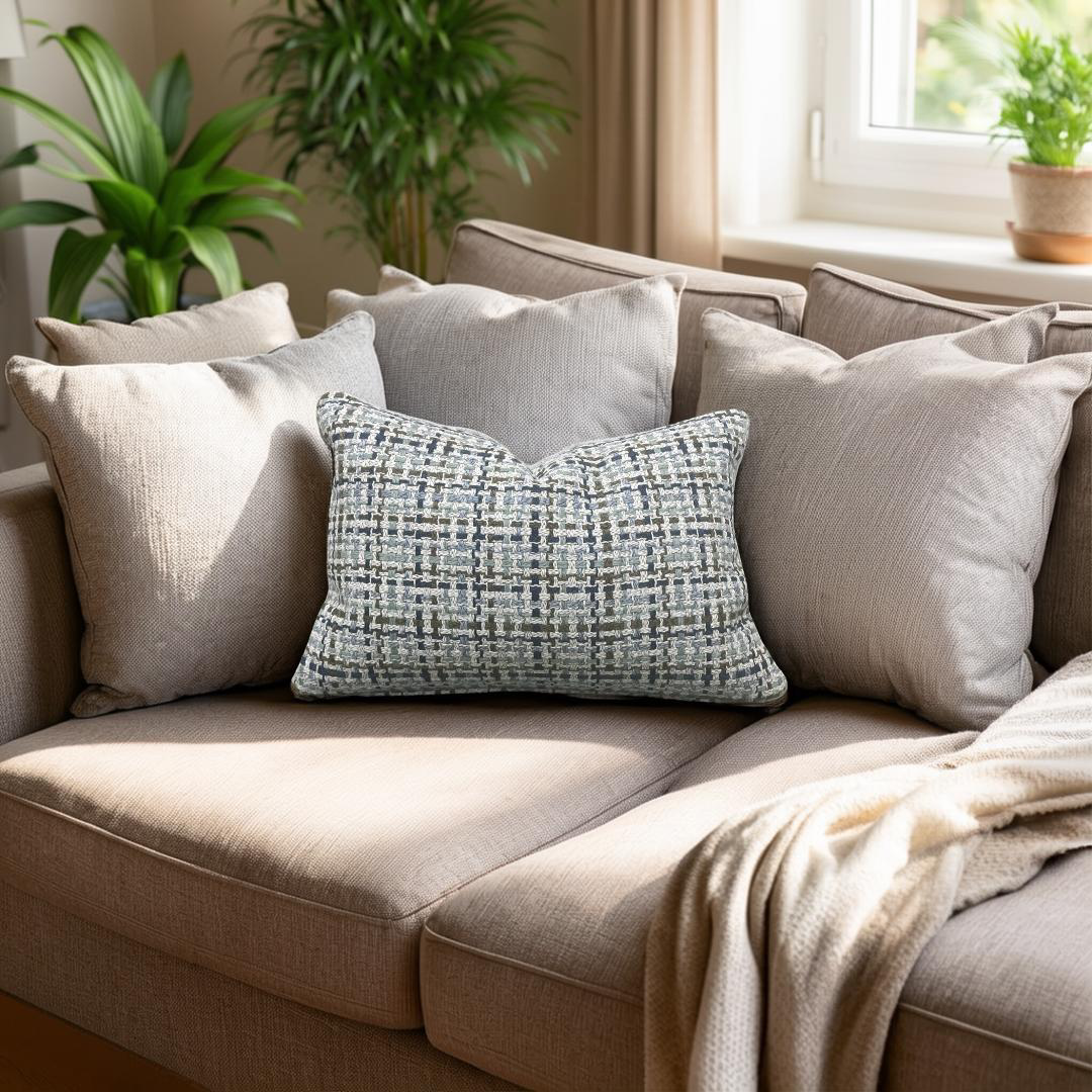 Beige sofa with patterned pillow and plants in a room