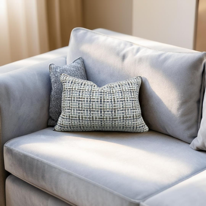 Gray sofa with patterned cushions in a softly lit room