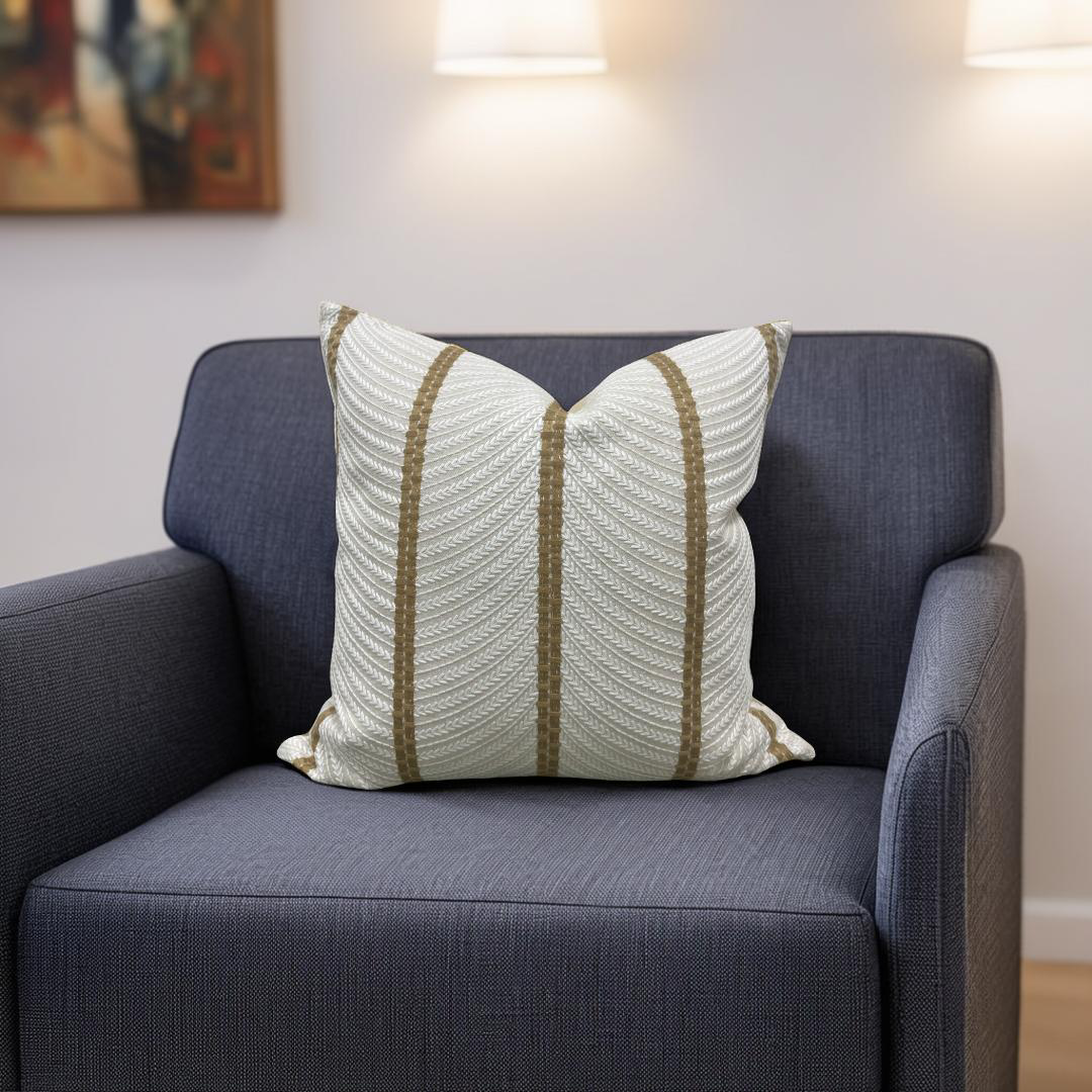 Decorative pillow with striped pattern on a gray sofa in a living room setting.