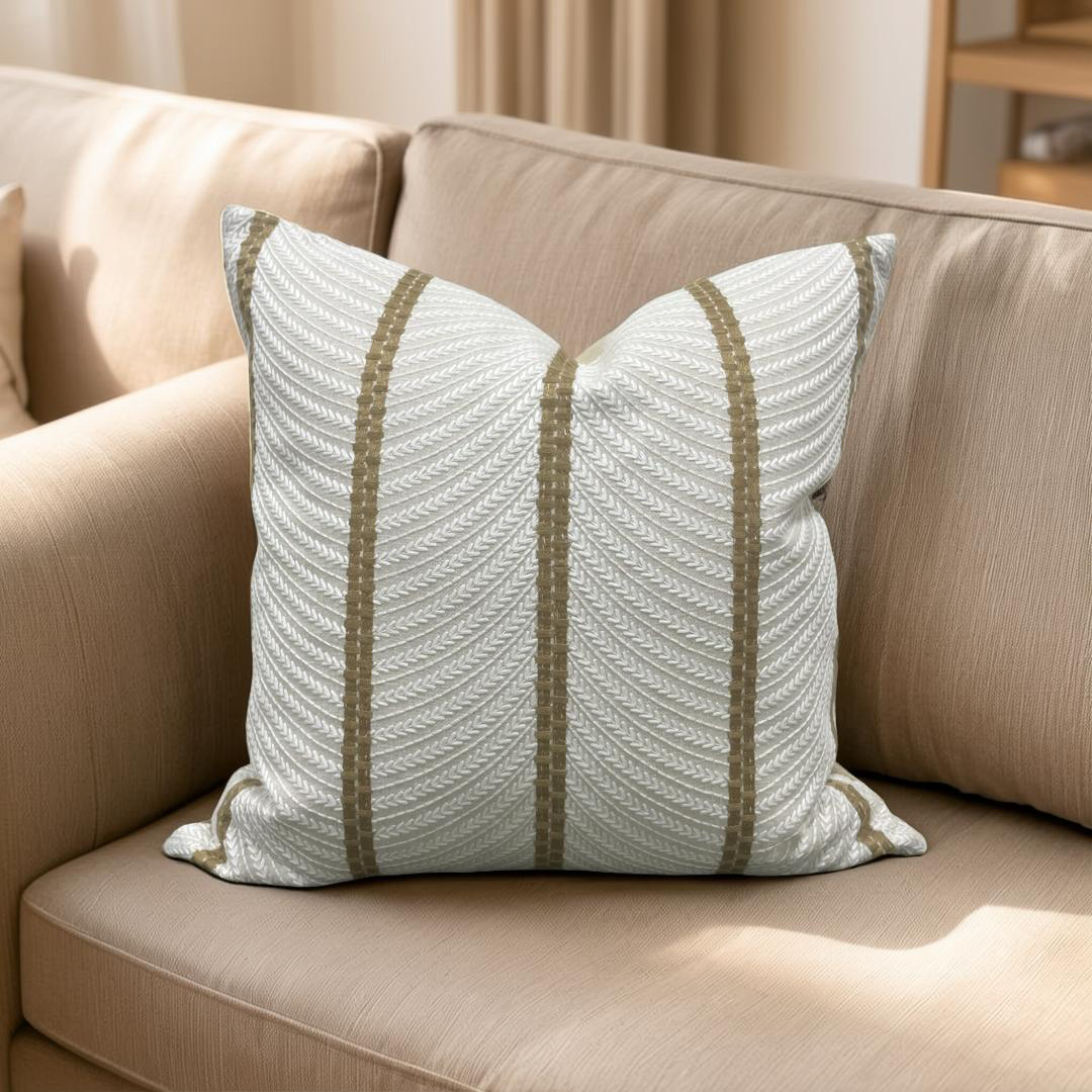 Decorative pillow with striped pattern on a beige sofa
