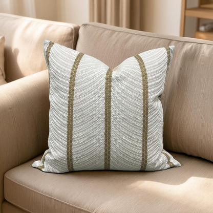 Decorative pillow with striped pattern on a beige sofa