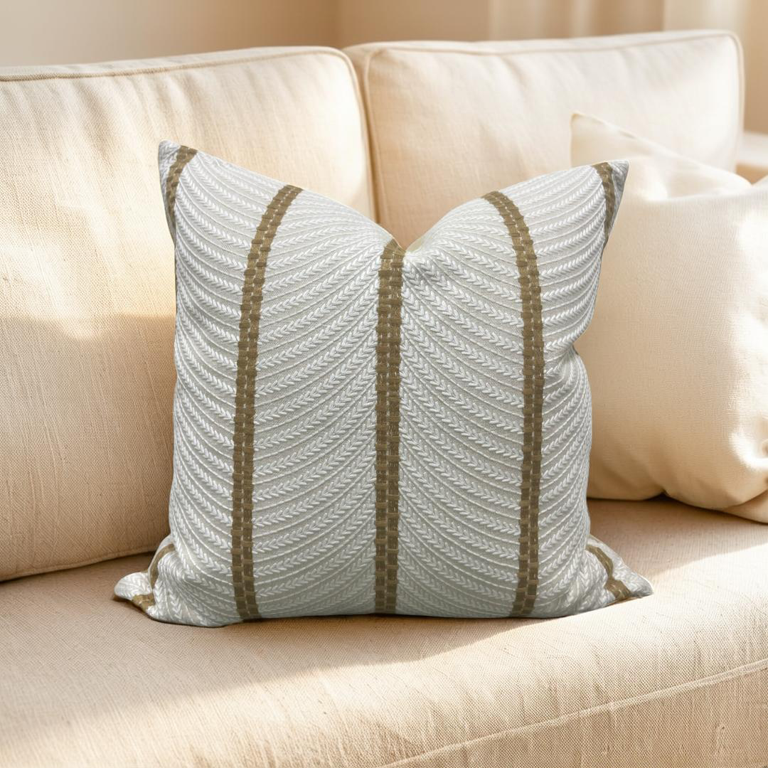 Decorative pillow with striped pattern on a beige sofa
