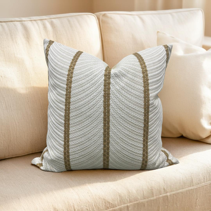 Decorative pillow with striped pattern on a beige sofa