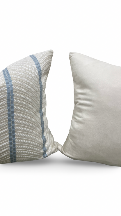 Two pillows, one with a textured pattern and the other plain, on a white background