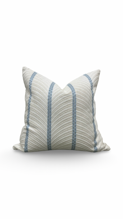 Striped pillow with blue and gray pattern on a white background