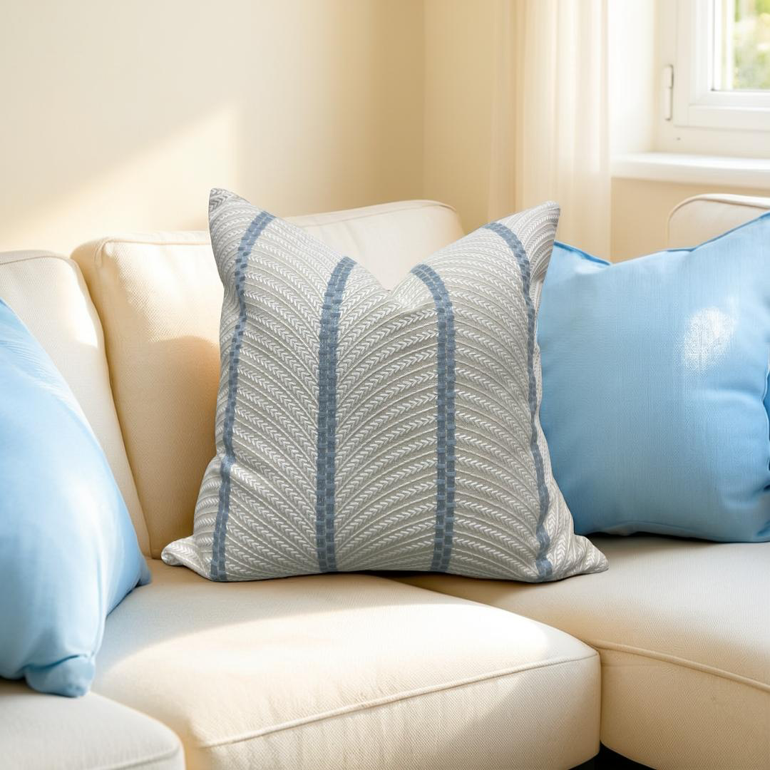 Decorative pillows on a beige sofa with a neutral background