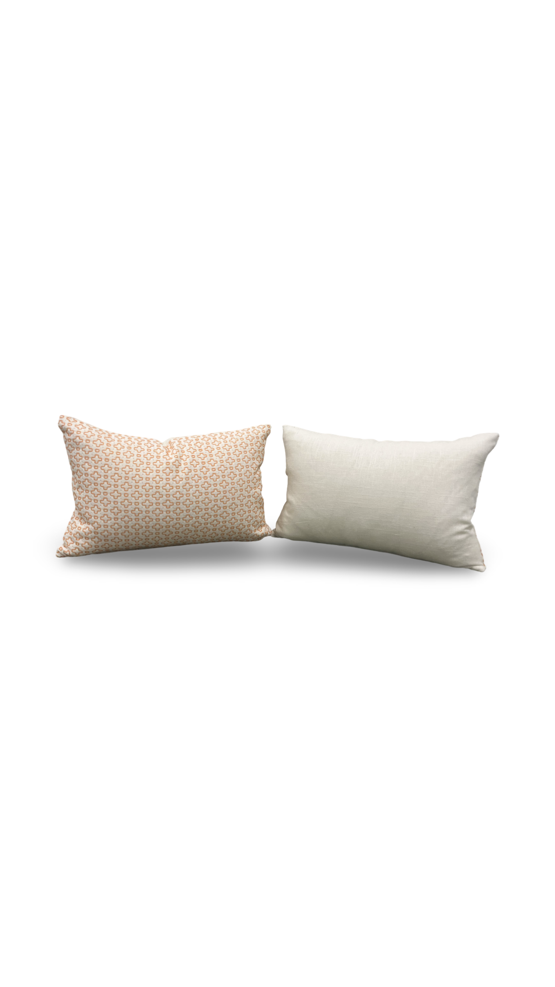 Two pillows, one beige with a subtle pattern and one white, on a white background