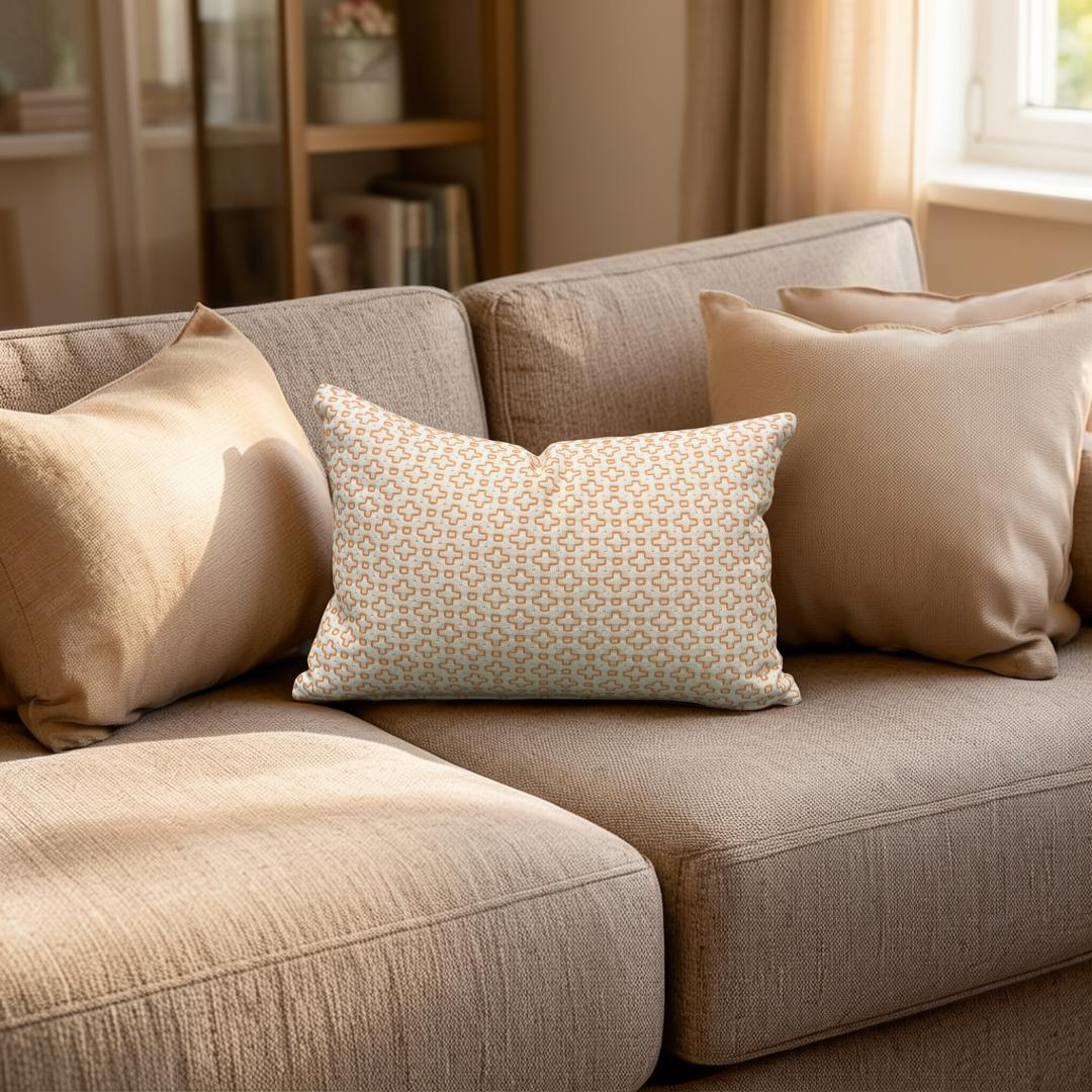 Beige sofa with patterned pillow in a cozy living room setting