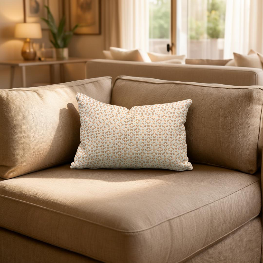 Beige sofa with a patterned pillow in a living room setting
