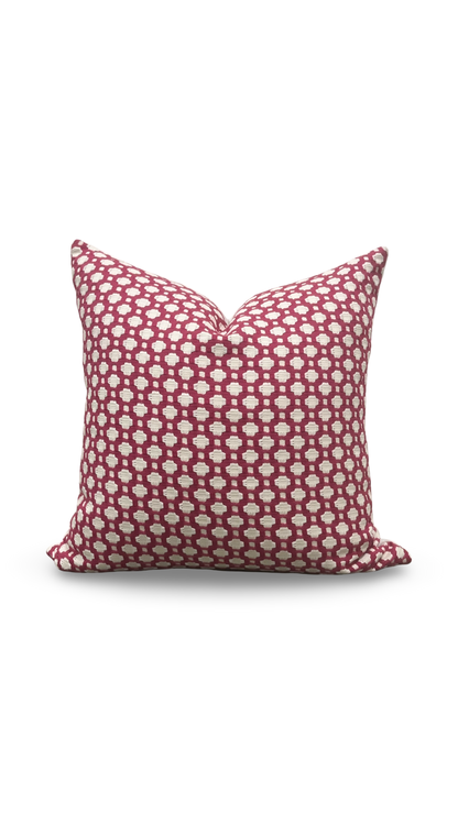 Decorative pillow with red and white pattern on a white background