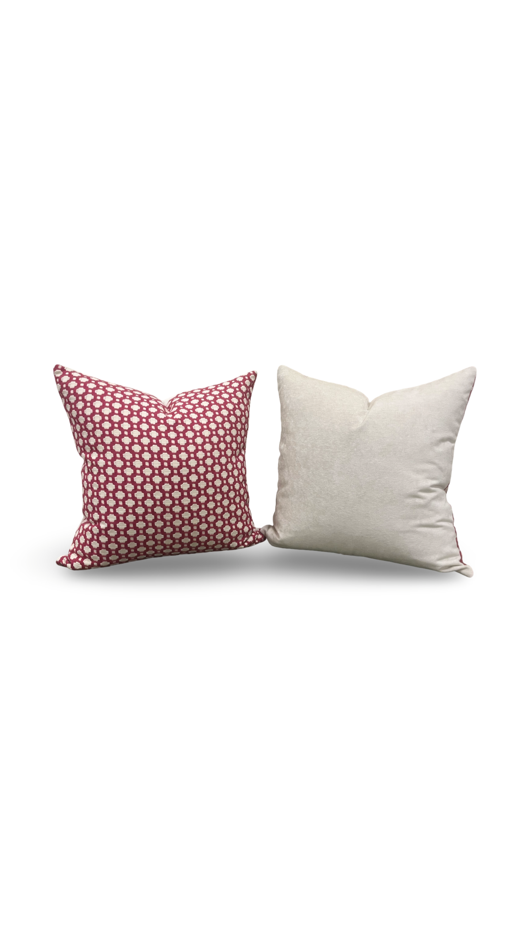 Two pillows, one with a pink polka dot pattern and the other plain white, on a white background.