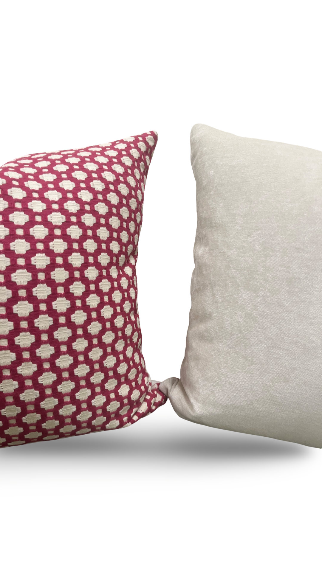 Two pillows, one with a red and white pattern and the other plain beige, on a white background.