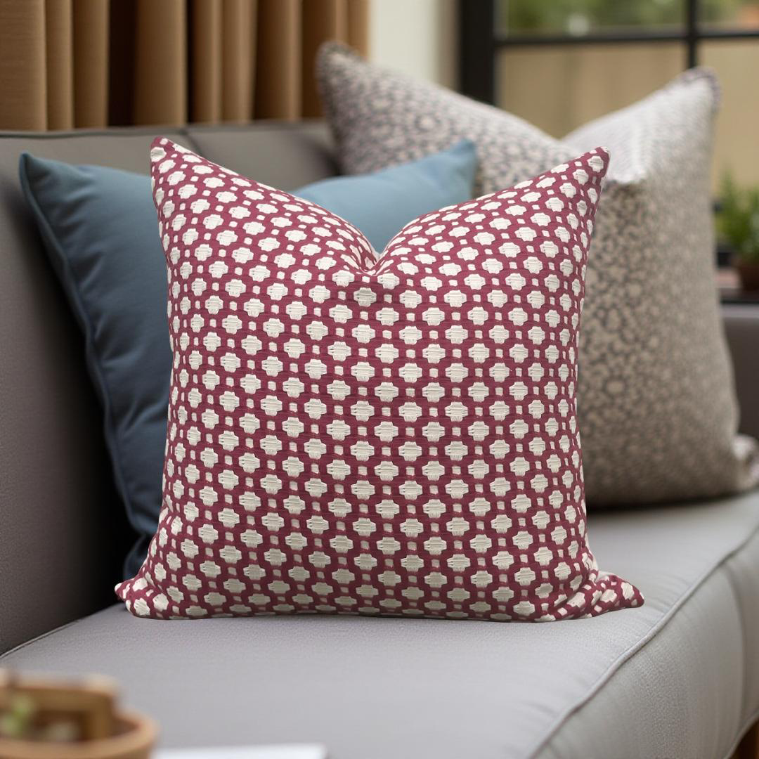 Patterned pillow on a sofa with other pillows in the background