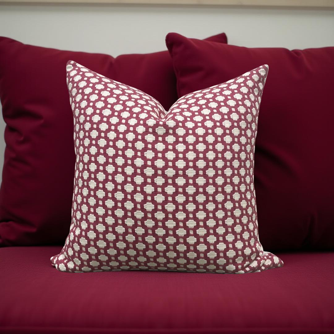 Patterned red pillow on a red sofa