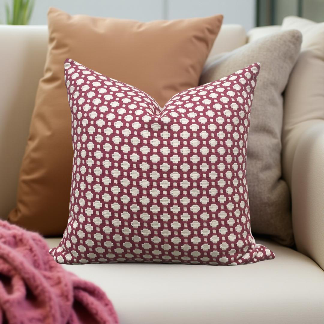 Patterned pillow on a beige sofa with a blurred background