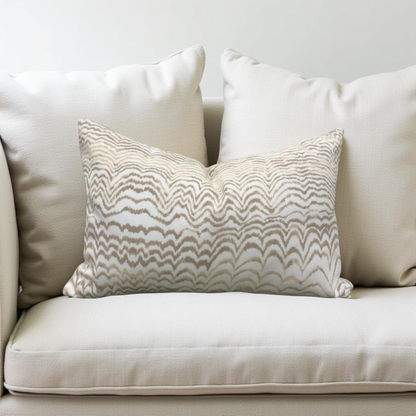 Decorative pillow with wavy pattern on a beige sofa