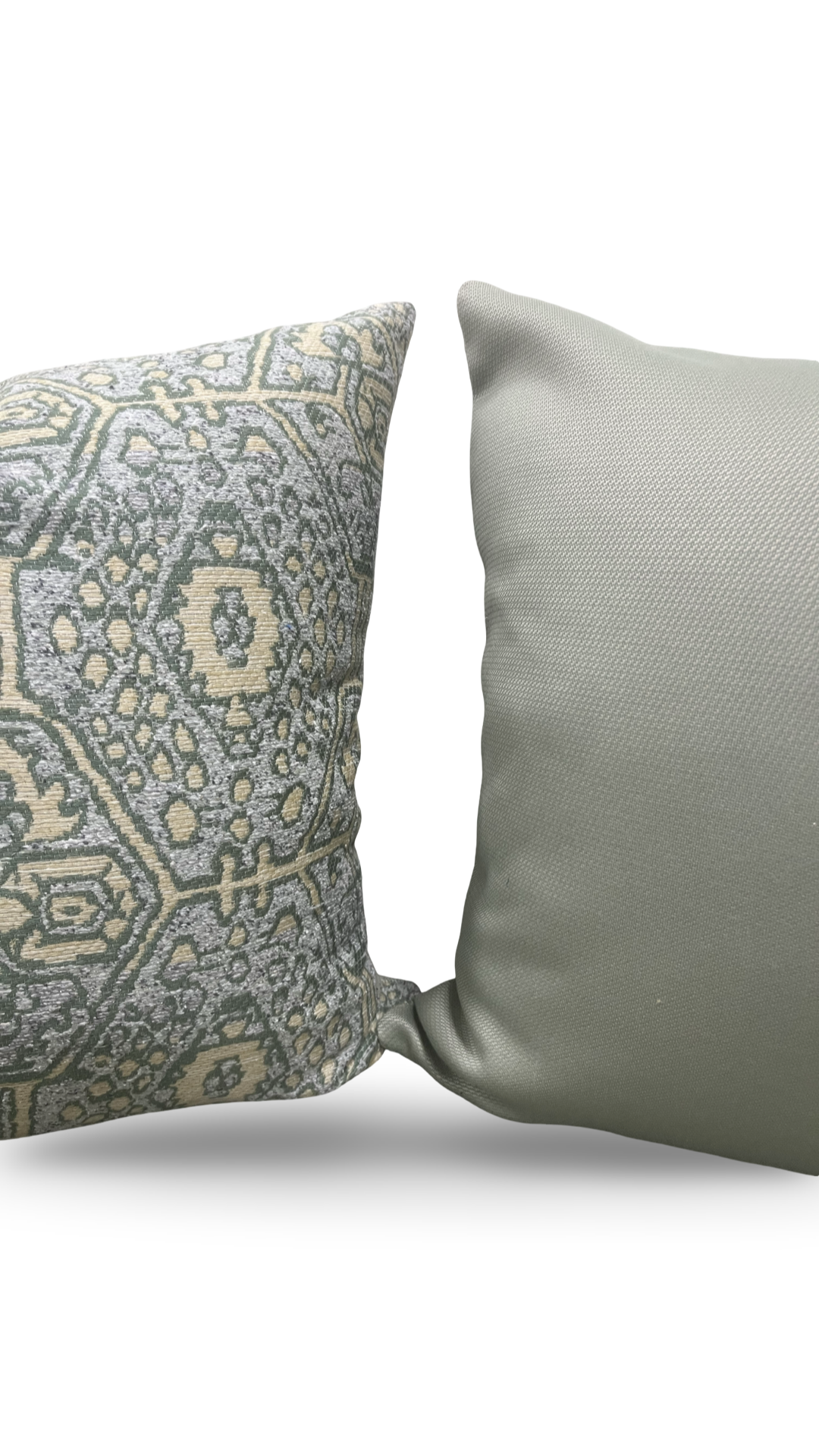 Two pillows, one with a geometric pattern and the other plain, on a white background