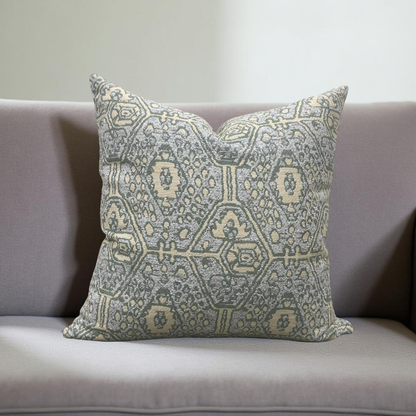 Decorative pillow with geometric pattern on a gray sofa