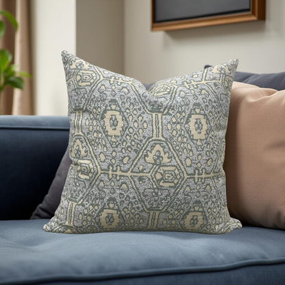 Decorative pillow with geometric pattern on a blue sofa