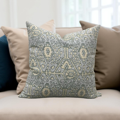 Decorative pillow with geometric pattern on a beige sofa